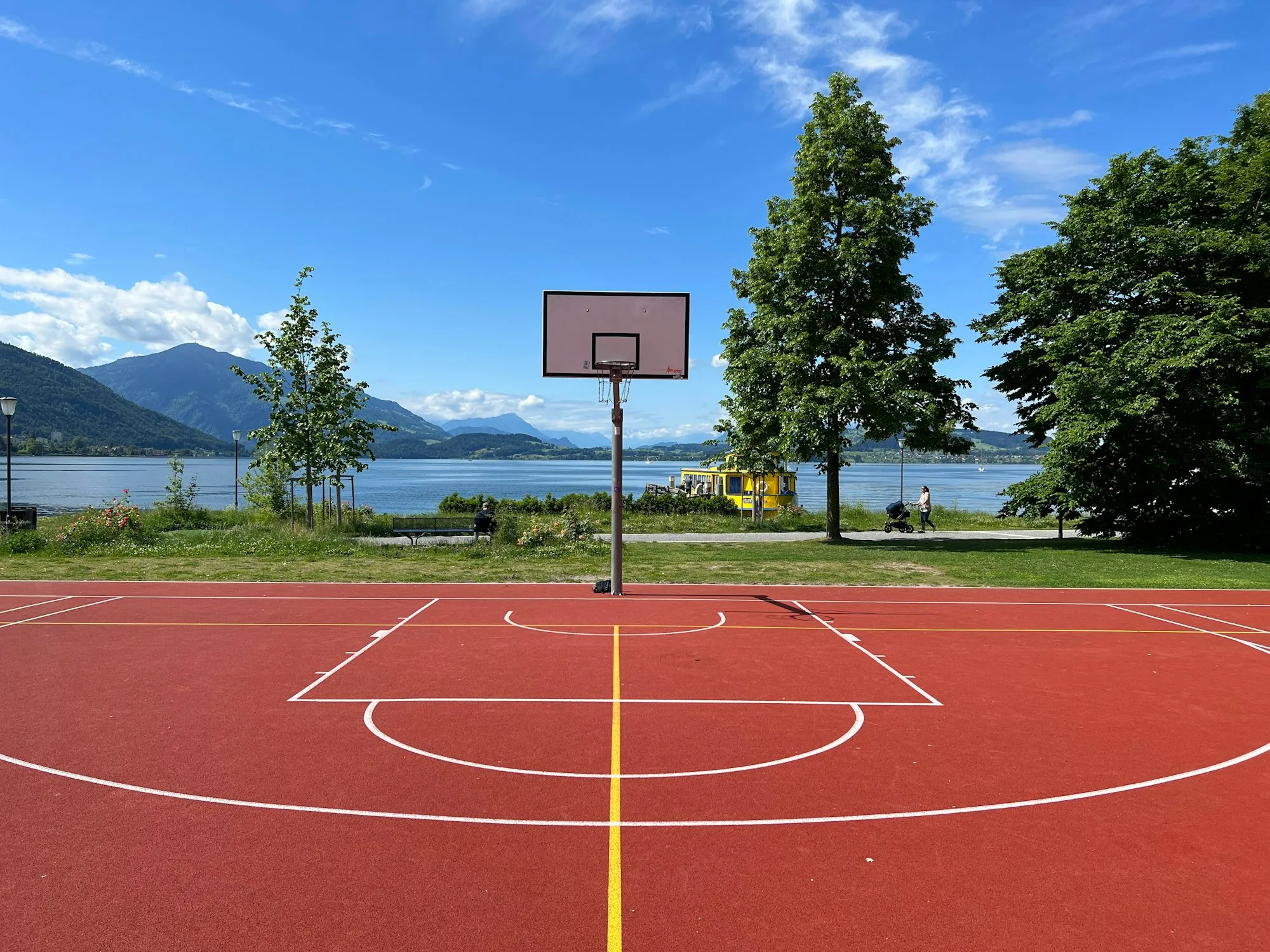 An outdoor basketball court on a clear day