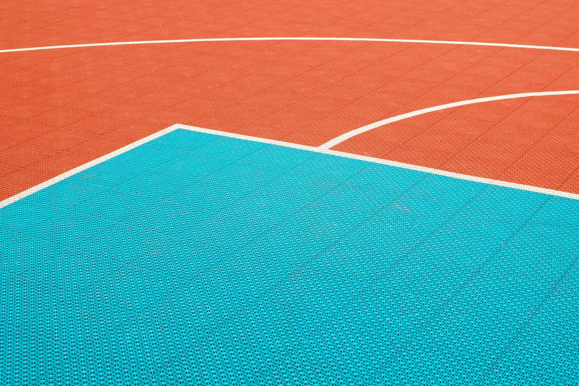 Court surface markings in orange and teal
