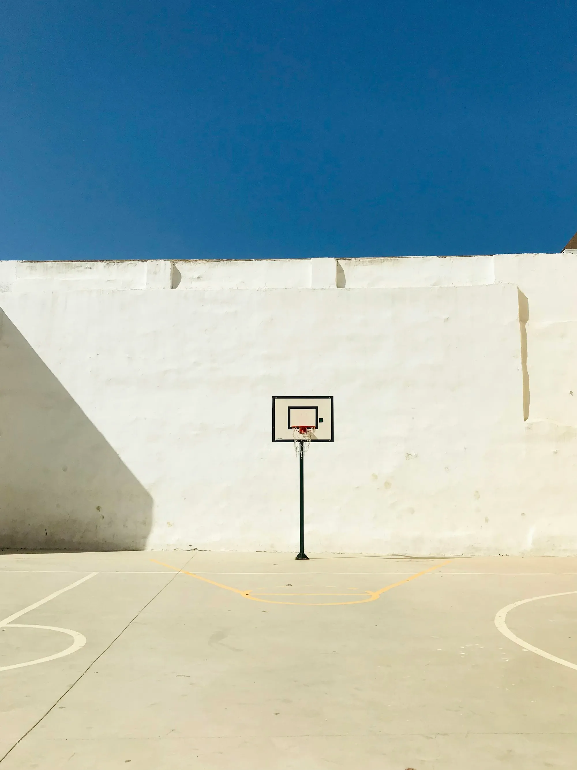 A basketball hoop against a plain white wall